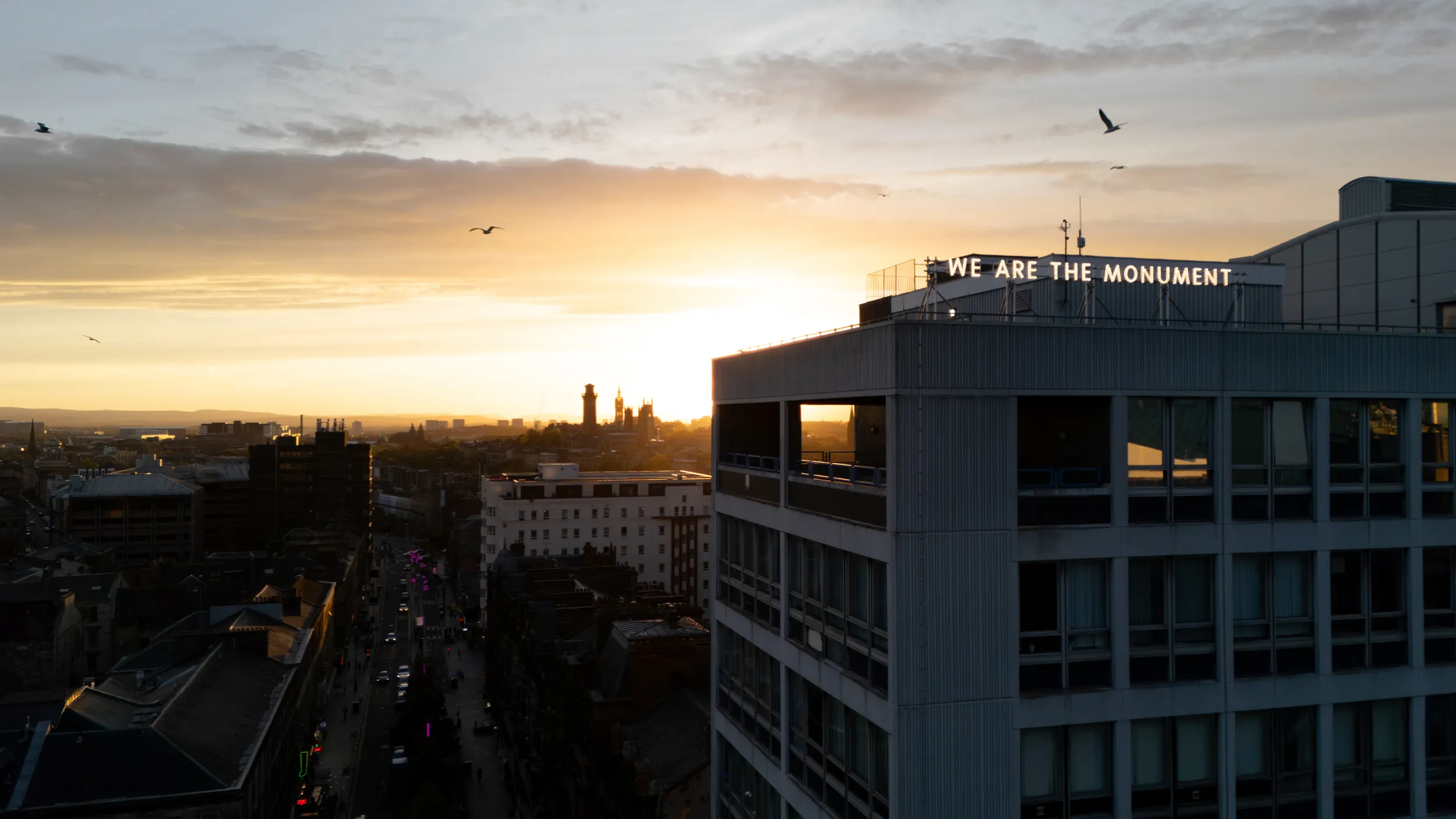 "We Are The Monument" lettering displayed on the rooftop of the Glasgow Dental Hospital